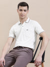 Man wearing a beige beige solid casual polo t shirt with pocket on a light gray background