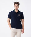 Man wearing a navy navy solid slim fit polo t shirt on a light gray background