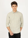 Man wearing a green green checked full sleeve 100% cotton casual shirt on a light gray background