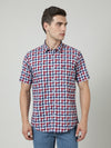 Man wearing a red red checked half sleeve shirt on a light gray background