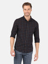 Man wearing a brown dark brown checked full sleeve casual shirt on a light gray background