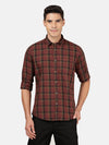 Man wearing a brown checked full sleeve brown shirt with casual styling on a gray background