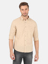 Man wearing a yellow golden yellow printed full sleeve casual shirt on a light gray background