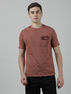 Man wearing a red dark red solid casual t shirt with casual styling on a gray background
