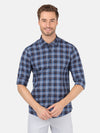Man wearing a navy checked full sleeve navy casual shirt with casual styling on a gray background