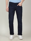 Man wearing a blue dark blue solid mid rise slim fit jean with casual styling on a gray background