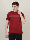 Man wearing a maroon printed casual t shirt on a light gray background