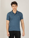 Man wearing a green olive green printed casual polo t shirt on a light gray background