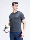 Man wearing a grey charcoal melange grey solid casual t shirt on a light gray background