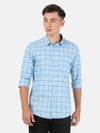 Man wearing a blue casual checked full sleeve blue shirt on a light gray background
