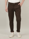 Man wearing a green olive green solid slim fit casual trouser with casual styling on a gray background