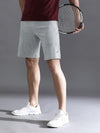 Man wearing a grey solid grey melange comfort fit track shorts on a light gray background