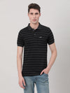 Man wearing a black striped casual black polo t shirt on a light gray background
