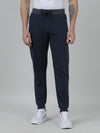 Man wearing a blue slim fit joggers blue in french terry on a light gray background