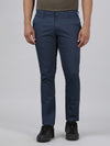 Man wearing a navy casual printed navy trouser on a light gray background