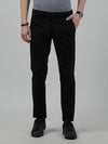Man wearing a black casual solid slim fit trouser black on a light gray background