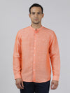 Man wearing a orange solid full sleeve linen casual shirt with casual styling on a gray background