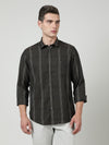 Man wearing a olive dark olive checked full sleeve shirt with casual styling on a gray background