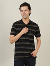 Man wearing a black black striped casual polo t shirt on a light gray background
