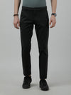 Man wearing a green olive green solid casual slim fit trouser on a light gray background