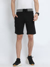 Man wearing a black black solid slim fit interlock track shorts on a light gray background