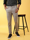 Man wearing a grey grey solid slim fit casual trouser with casual styling on a gray background
