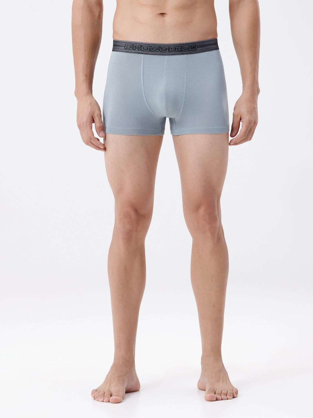 Man wearing light blue boxer briefs on a white background
