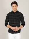 Man wearing a black printed full sleeve 100% cotton black shirt with casual styling on a gray background