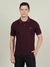 Man wearing a red beetroot red printed polo t shirt with casual styling on a gray background