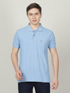 Man wearing a blue casual polo t shirt solid blue with pocket with casual styling on a gray background
