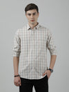 Man wearing a beige beige checked full sleeve casual shirt on a light gray background