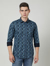 Man wearing a navy navy printed full sleeve 100% cotton shirt on a light gray background