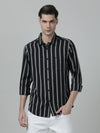Man wearing a black black striped full sleeve 100% cotton shirt on a light gray background