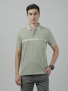 Man wearing a green olive melange green printed polo t shirt with casual styling on a gray background