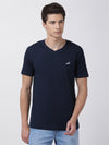 Man wearing a navy sport navy tee in breathable jersey on a light gray background