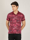 Man wearing a red casual red printed polo t shirt with casual styling on a gray background