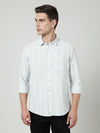 Man wearing a blue casual blue striped full sleeve shirt with casual styling on a gray background