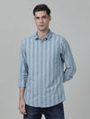 Man wearing a blue light blue striped full sleeve 100% cotton casual shirt with casual styling on a gray background