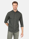 Man wearing a green checked full sleeve green casual shirt with casual styling on a gray background