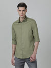 Man wearing a green moss green solid full sleeve shirt on a light gray background