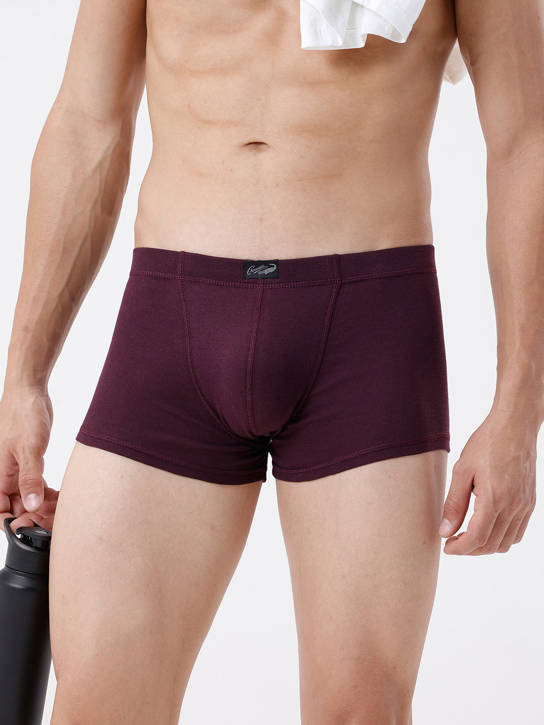 Maroon underwear worn by a person on a white background