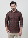 Man wearing a brown rust brown checked full sleeve 100% cotton shirt with casual styling on a gray background