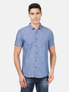 Man wearing a blue printed half sleeve 100% cotton blue shirt on a light gray background