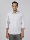 Man wearing a grey grey printed casual full sleeve 100% cotton shirt on a light gray background