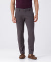 Man wearing a grey textured essential chinos in dark grey with casual styling on a gray background