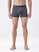 Person wearing gray boxer briefs on a white background