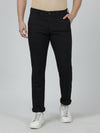Man wearing a black solid slim fit black casual trouser on a light gray background