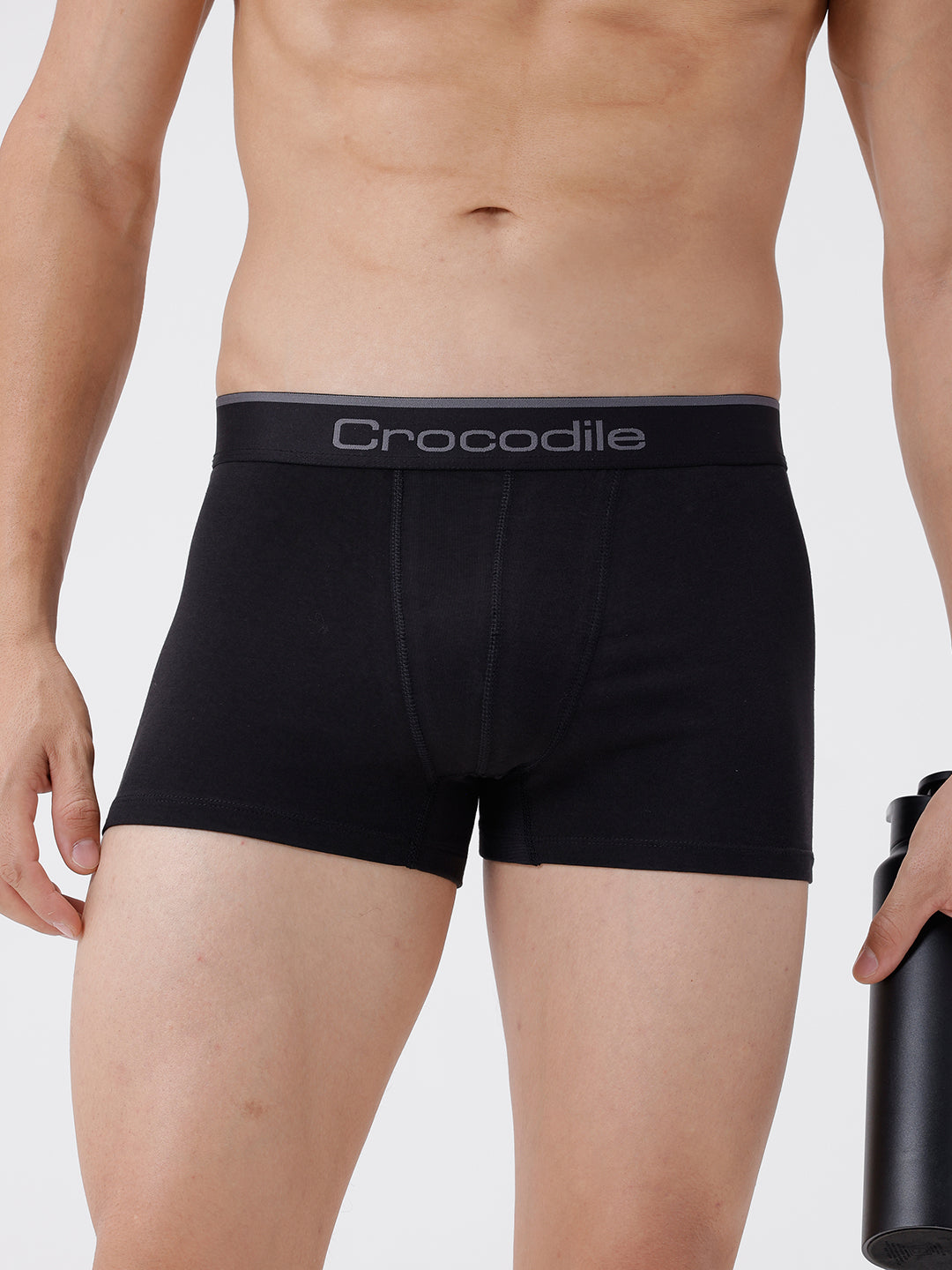 Black boxer briefs with 'Crocodile' branding worn by a person on a light gray background