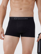Black boxer briefs with 'Crocodile' branding worn by a person on a light gray background