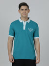 Man wearing a green green solid polo t shirt on a light gray background